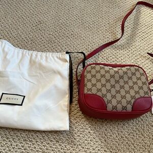 Gucci canvas camera bag in red. New and comes with dust bag.